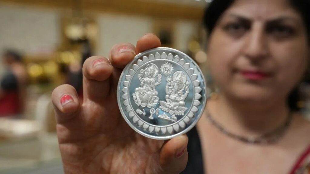 Silver, gold retreat from record highs on strong US dollar, weak global cues
